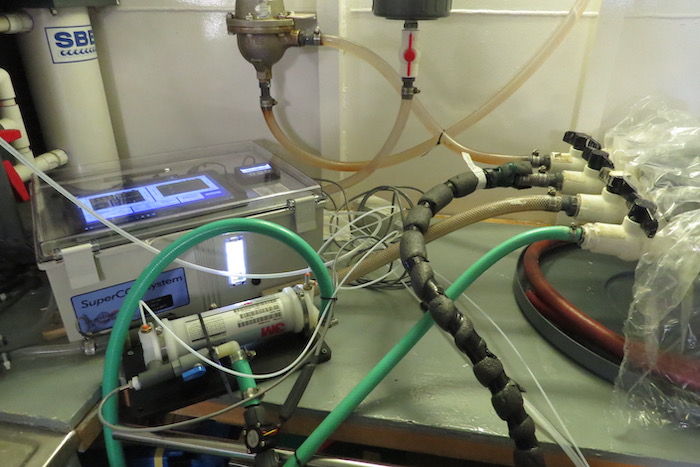 Figure 3. The automated underway sea surface partial pressure of carbon dioxide; system (SUPER- carbon dioxide partial pressure Sunburst Sensors) in the CCGS Louis S. St-Laurent. An infrared analyzer contained in the white box (center left) is used to analyze air equilibrated with seawater in a gas exchanger (left, white cylinder attached to the green hose). Seawater is taken from the ship&#39;s seawater line (green hose at right). Photo courtesy of Michael DeGrandpre.